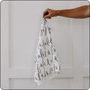 Soft and absorbent Christmas tea towel with 'Fa La La' script, held for size reference