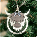 Rustic Highland cow Christmas ornament hanging on a festive tree