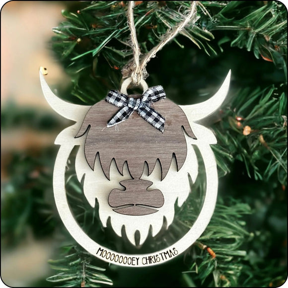 Rustic Highland cow Christmas ornament hanging on a festive tree