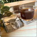 Highland cow slate coaster in use with a coffee mug, protecting surfaces in style