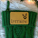 Personalized Christmas stocking featuring a pawprint with antlers design and engraved name patch, great for pet lovers
