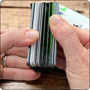 Minimalist metal wallet opened to display card slots and secure storage