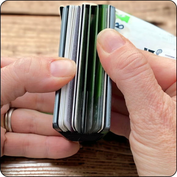 Minimalist metal wallet opened to display card slots and secure storage